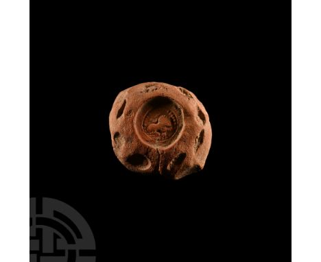3rd-4th century A.D. Plano-convex terracotta disc with seal-impression of a lion in a ring of pellets. 19.1 grams, 40 mm (1 5