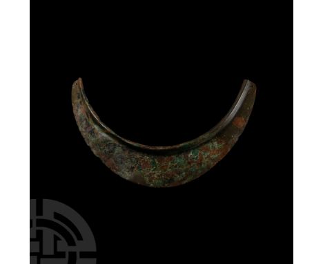 3rd-2nd century B.C. Semi-circular in shape, flat, the upper part raised, the lower one fitted with two fastening holes for t