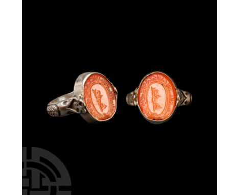 19th century A.D. Carnelian bezel with inscribed names of Muhammed and twelve Imams, in a later silver finger ring. 13.18 gra