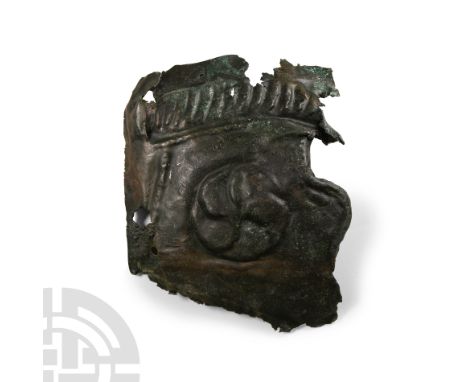 3rd century A.D. From the right side of the face mask, the upper edge with a band of embossed diagonal lines, probably intend