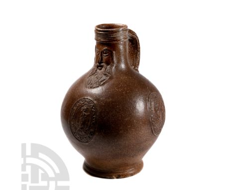 Late 16th-17th century A.D. Retaining its handle and featuring a stylised face in relief, three raised oval medallions to the