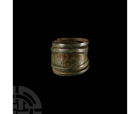 9th-11th century A.D. Punched ring-and-dot decoration to the expanded central section, orderly striations of pecking over the