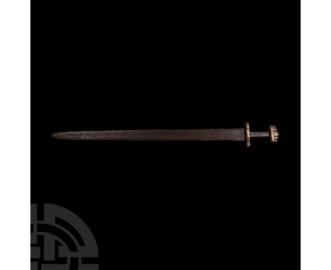 8th-10th century A.D. Comprising a double-edged tapering blade showing shallow fullers and wide cutting edges; boat-shaped lo