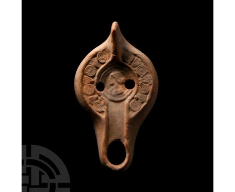 Circa 4th century A.D. With an integral thumb pad and basal ring, raised motif to discus portraying a bust within a roundel, 