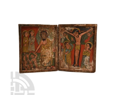 Circa 1550 A.D. Composed of a pair of recessed panels forming folding doors; the right panel with painted crucifixion scene d