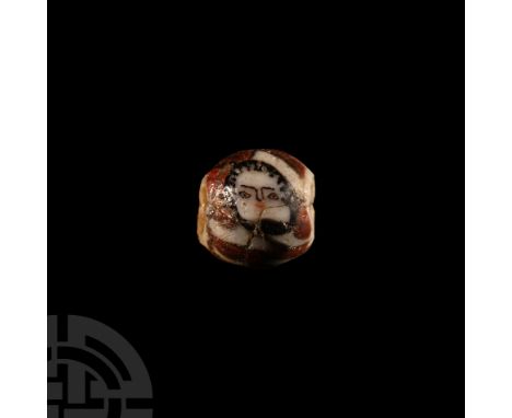 1st century B.C.-1st century A.D. Of roughly spherical form, opaque polychrome checked design incorporating two stylised huma