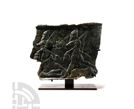 Circa 9th century B.C. Displaying a corrugated rim above and below; two advancing soldiers, each striding forwards over the h