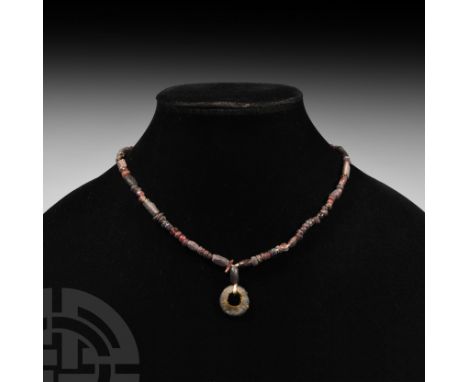 Circa 1st millennium B.C. or later. A restrung designer necklace composed of early drawn and lampwork glass, mostly oblate fo