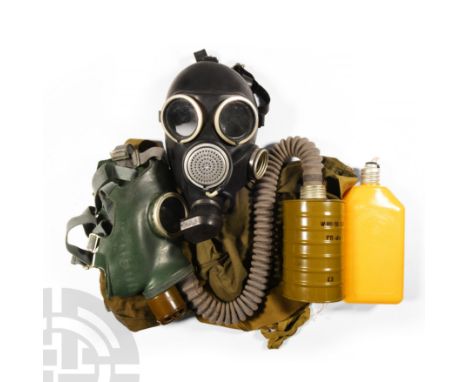 1940s A.D. Comprising two masks accompanied by a fabric bag, one mask with connecting pipe and respirator. 2.1 kg total, bag 