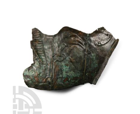 3rd century A.D. From the right side of the face mask, the upper edge with an embossed band of diagonal lines, Jupiter’s eagl