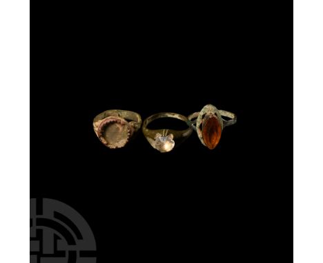 Circa 19th century A.D. The trio composed of different styles of finger ring, the bezels set with glass inlays, including two