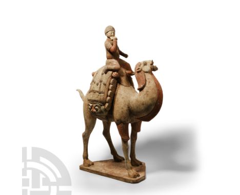 Tang Dynasty, 618-907 A.D. Modelled in the round advancing on a polygonal base, head tossed backwards and mouth open exposing