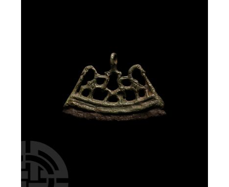 10th-11th century A.D. Shown addorsed in a stylised openwork design, central suspension loop and iron steel with crescentic p