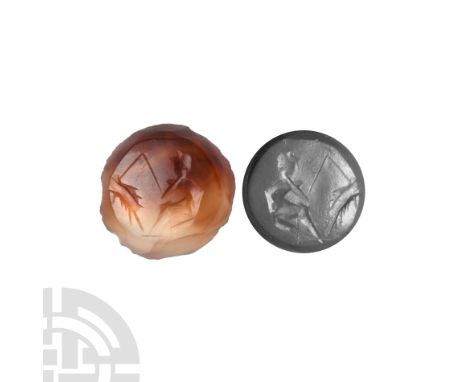 Circa 1st century A.D. Engraved on a circular carnelian stone, displaying a seated fisherman with a fish on his line; accompa