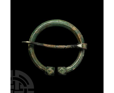 9th-11th century A.D. The body hexagonal in cross-section, facetted terminals and free-running tongue, punched ring-and-dot m