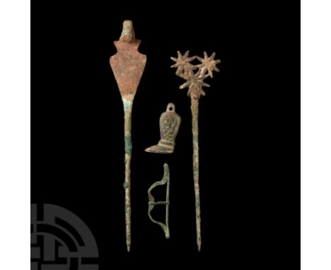 1st millennium B.C. and later. Comprising: a bow-shaped buckle; a boot-shaped pipe tamper with suspension loop; pin with trio