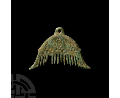 9th-11th century A.D. Comprising a roughly semi-circular profile, suspension lug to apex, slightly flared arms with zoomorph 