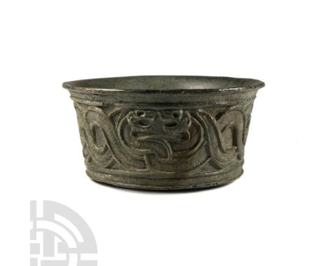3rd-2nd millennium B.C. Carved with squat, vertical sidewall and everted rim, frieze of entwined snakes with opposed heads be