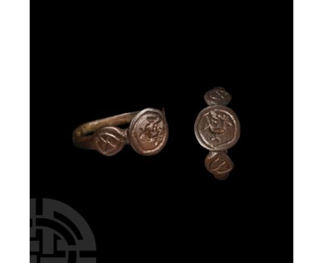 3rd-4th century A.D. Large disc bezel with standing bird and cross(?) within a ring, flanking discs with saltire in a ring. 2