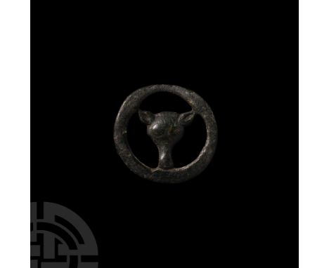 9th-12th century A.D. Comprising an outer ring with wolf mask in low relief at the centre. Cf. MacGregor, A. et al., A Summar