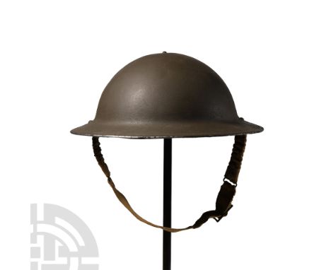 1939-1945 A.D. Standard issue steel helmet with leather liner and fabric chin-strap, finished green. 1.14 kg, 31 wide (12 1/4