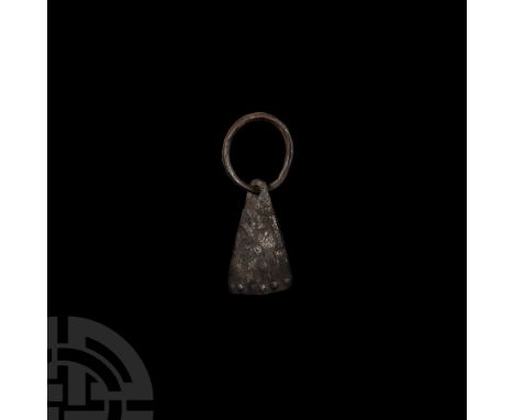 Circa 9th-11th century A.D. Composed of a free-running wedge-shaped head with sun burst to one face and repoussé pellets to t