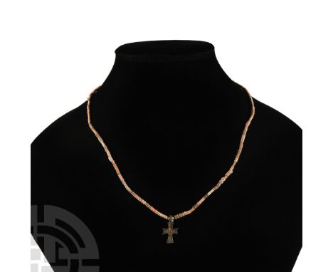 Circa 10th century A.D. and later. Composed of later restrung ceramic beads together with a central cruciform pendant display