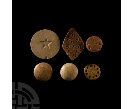 1st-4th century A.D. Most discoid in form and displaying a variety of designs: a ring of dimples; dot-in-ring motifs within r