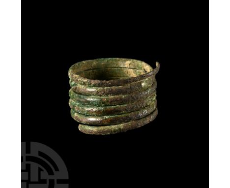 9th-11th century A.D. Composed of six slender tiers with slightly convex outer faces. 4.26 grams, 22.42 mm overall, 19.16 mm 
