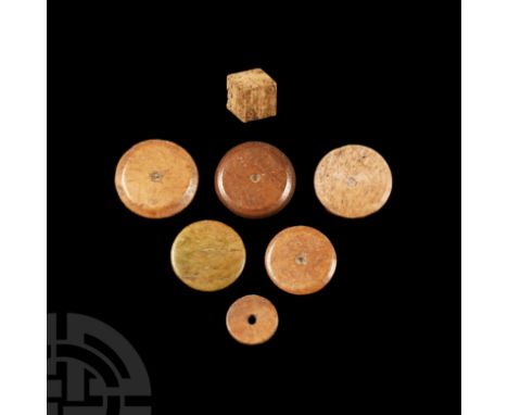 1st-4th century A.D. Comprising six polished discoid counters and a single dice, the latter configured: 1:6; 2:5; 3:4 in punc
