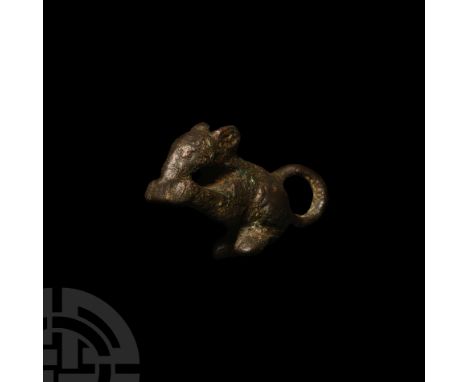 2nd-3rd century A.D. Modelled in the round with recurved tail forming a suspension loop; its front paws raised to its mouth, 