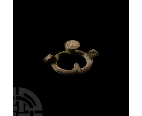 1st century B.C.-1st century A.D. Round-section hoop with three radiating animal-heads, discoid stud with quincunx of ring-an