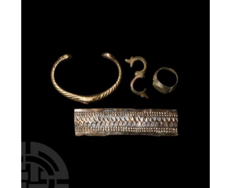 1st millennium A.D. and later. Comprising: a sheet-metal bar displaying repoussé geometric decoration; penannular bracelet wi