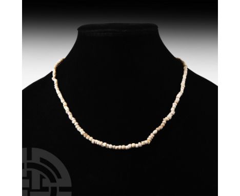 1st millennium B.C. and later. Comprising cream-coloured stone or shell beads of various types, including one decorated with 