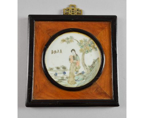 Chinese circular porcelain plaque decorated with a lady in a garden and calligraphy, 9.7cm diameter,