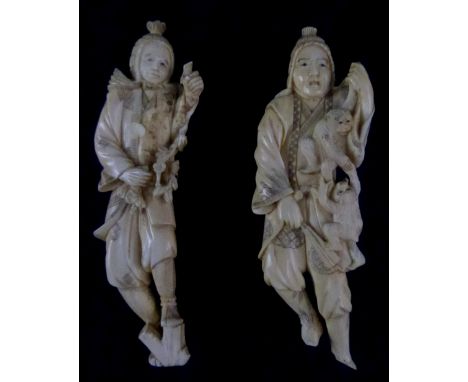 Pair of early 20th century Japanese carved ivory okimono, one figure with monkeys and the other with flowers, each approximat