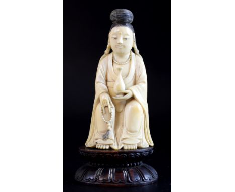 Chinese carved ivory figure of a Guan Yin, on carved wood base which bears Cornelius Gillmore Collection label, the figure 11