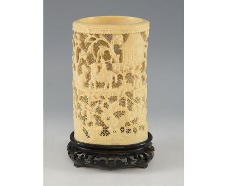 19th century Chinese relief carved ivory tusk with figures in a landscape setting, on hardwood base, 19.5cm high not includin