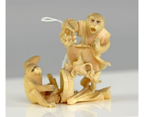 Early 20th century Japanese carved ivory group of two monkeys, one robed holding a bunch of fruit, 7cm high,PLEASE NOTE: THIS