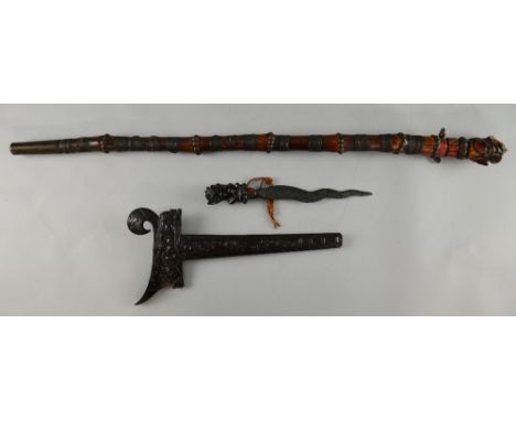 Malayan Kris with beast handle and extensively carved sheath, 39cm long, and a bamboo stick with metal bindings and painted b