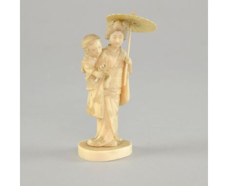 Early 20th century Japanese carved ivory okimono depicting the figure of a bijin standing holding a parasol whilst her son cl