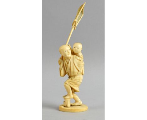 Early 20th century Japanese carved ivory okimono of a man carrying a fishing net and a boy riding on his back, signed to base