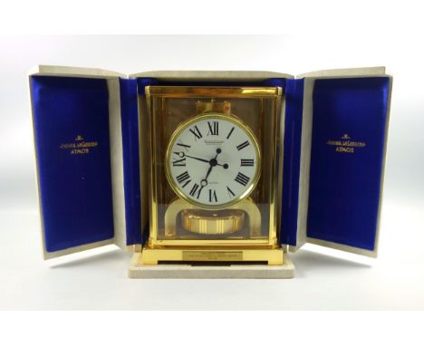 Jaeger-LeCoultre presentation Atmos timepiece with a circular white enamelled dial with Roman numerals enclosing a 400 day mo