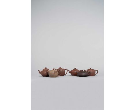 SIX CHINESE YIXING TEAPOTS AND COVERS QING DYNASTY/REPUBLIC PERIOD  Variously decorated with chrysanthemum, bamboo, and one a