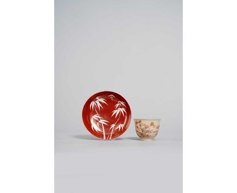 A CHINESE RED-GROUND DISH AND A CAFE-AU-LAIT CUP QING DYNASTY The dish painted with leafy bamboo and a bat above, the reverse