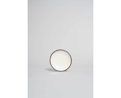 A CHINESE WHITE-GLAZED DING DISH WITH GUAN (OFFICIAL) MARK  NORTHERN SONG DYNASTY  Covered in a lustrous creamy-white glaze a