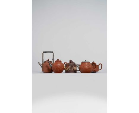 FIVE CHINESE YIXING TEAPOTS AND COVERS 18TH CENTURY  Variously shaped and decorated with flowers, foliage, bamboo, pine and d