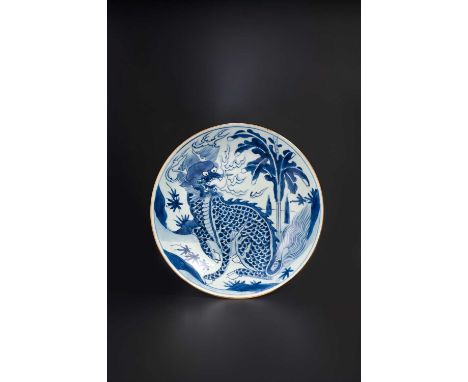 A CHINESE BLUE AND WHITE 'QILIN' DISH EARLY KANGXI, 17TH CENTURYBoldly painted with a scaly fire-breathing qilin beside a pla