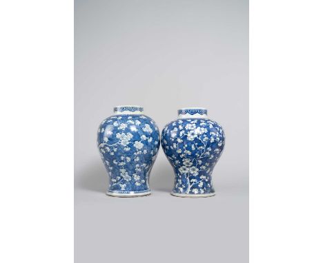 TWO CHINESE BLUE AND WHITE 'PRUNUS' BALUSTER VASES KANGXI 1662-1722Each painted with blossoming prunus branches on a cracked-