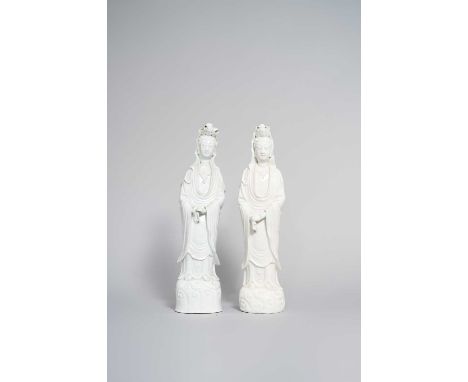 TWO CHINESE BLANC DE CHINE FIGURES OF GUANYIN 18TH CENTURYBoth standing on scroll bases and wearing long flowing robes, 44cm 